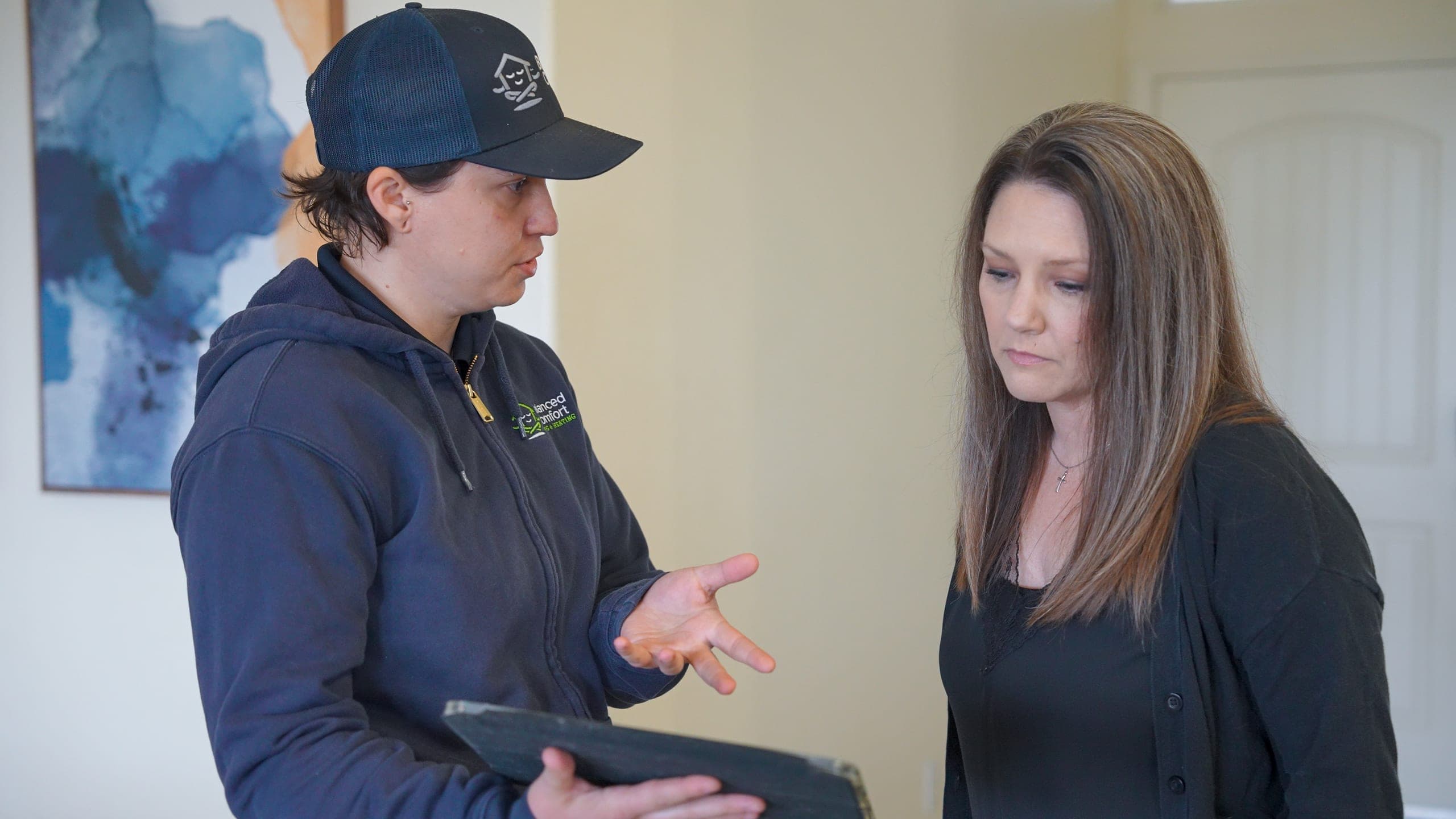 Balanced Comfort technician discussing indoor air quality options with a homeowner