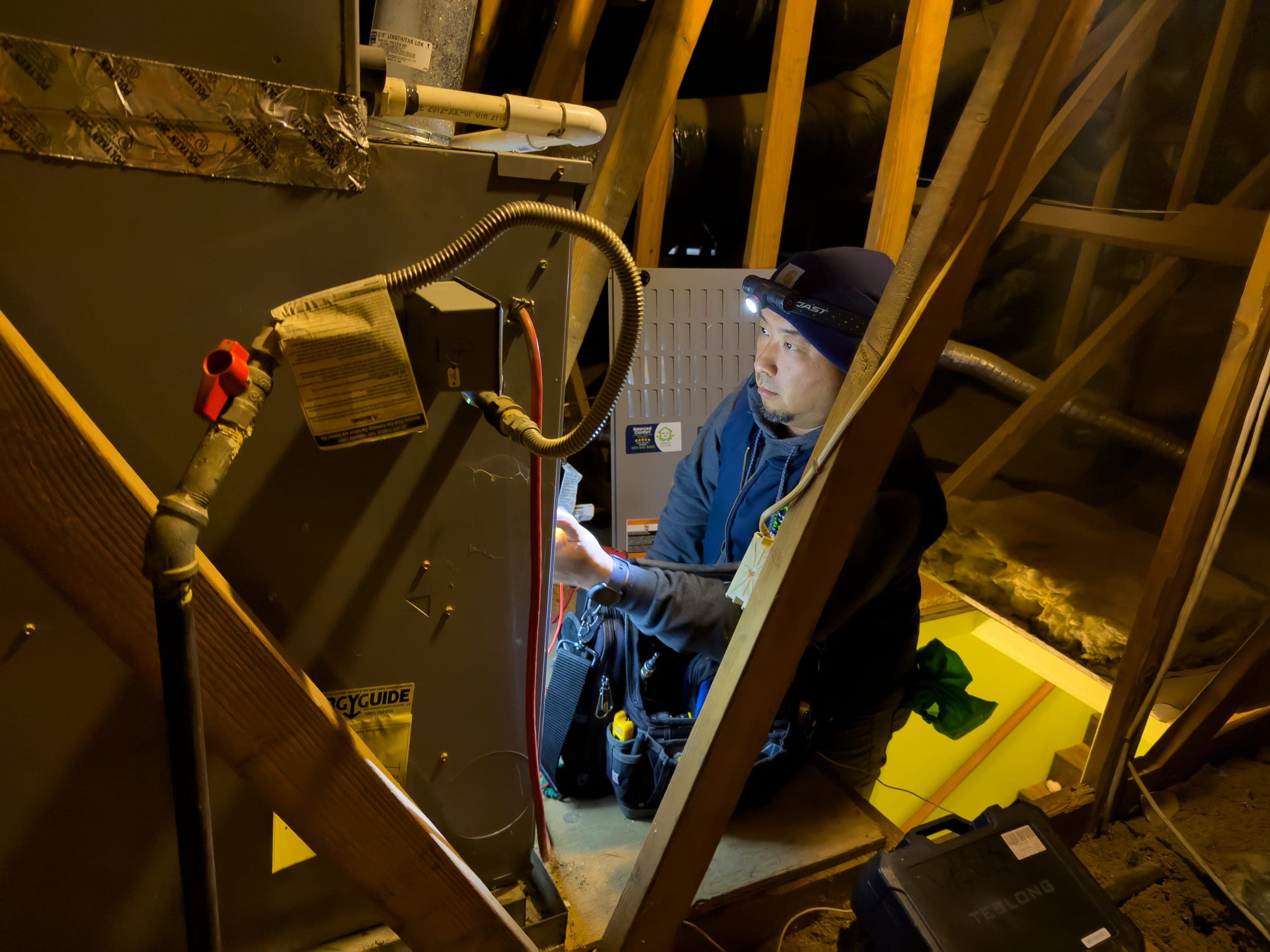 Balanced Comfort technician repairing a gas heating system