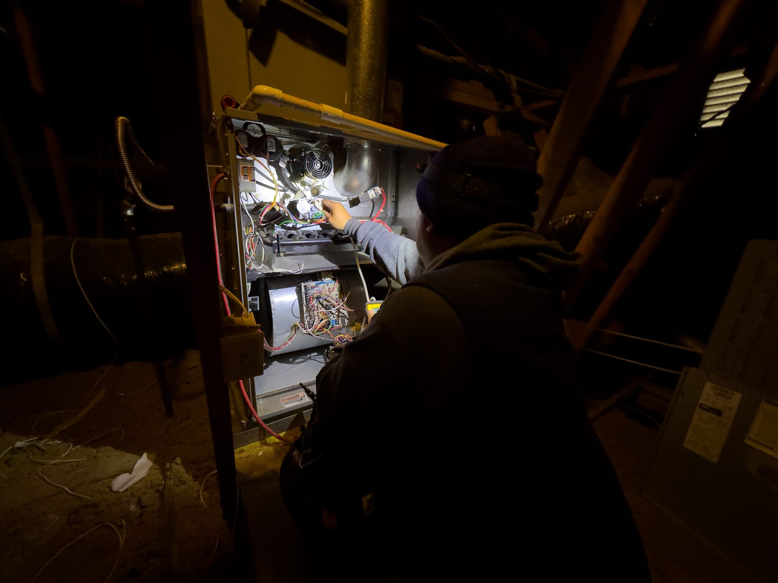 Balanced Comfort technician repairing a gas heating system