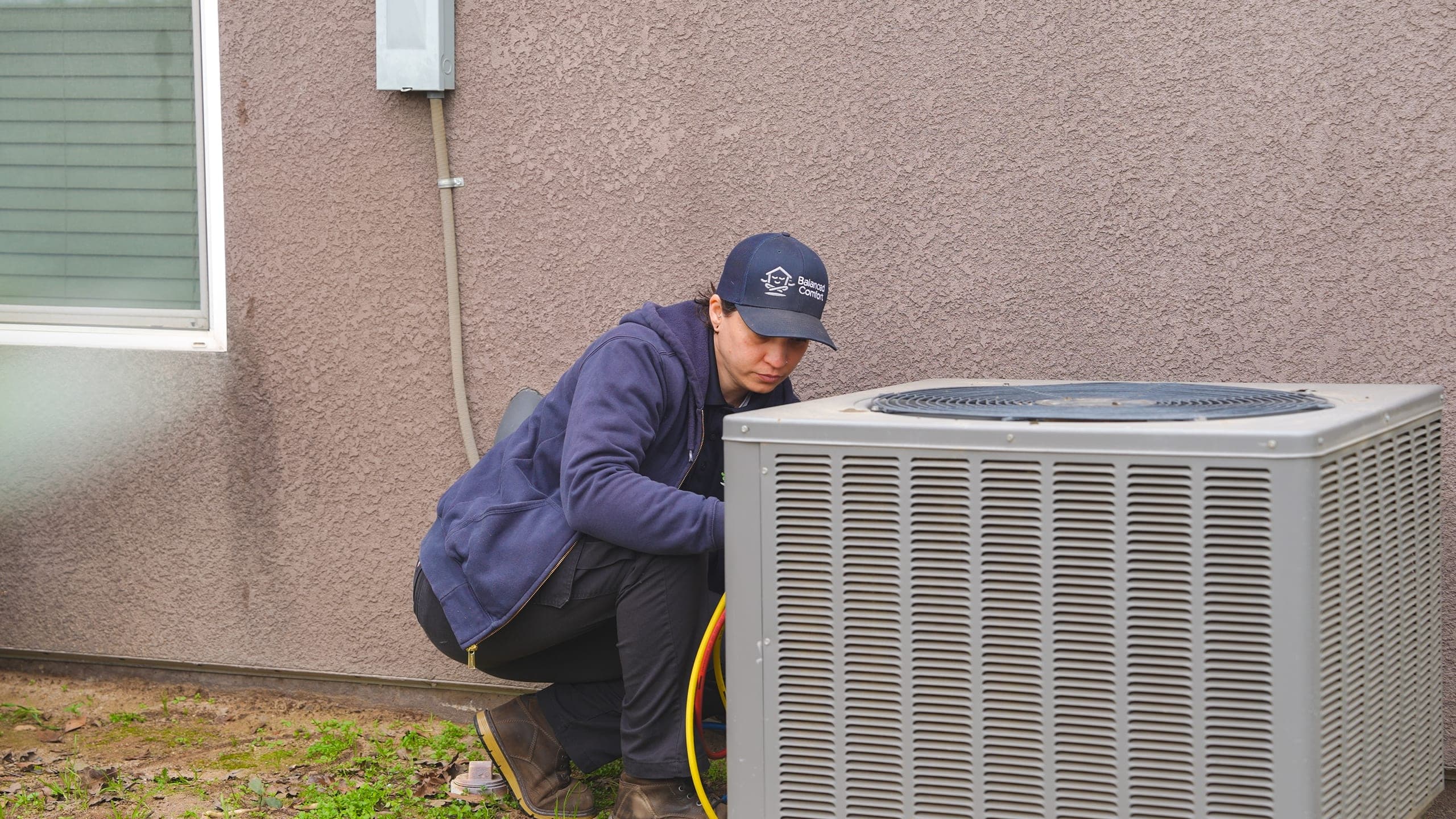 Balanced Comfort technician servicing a mini-split system
