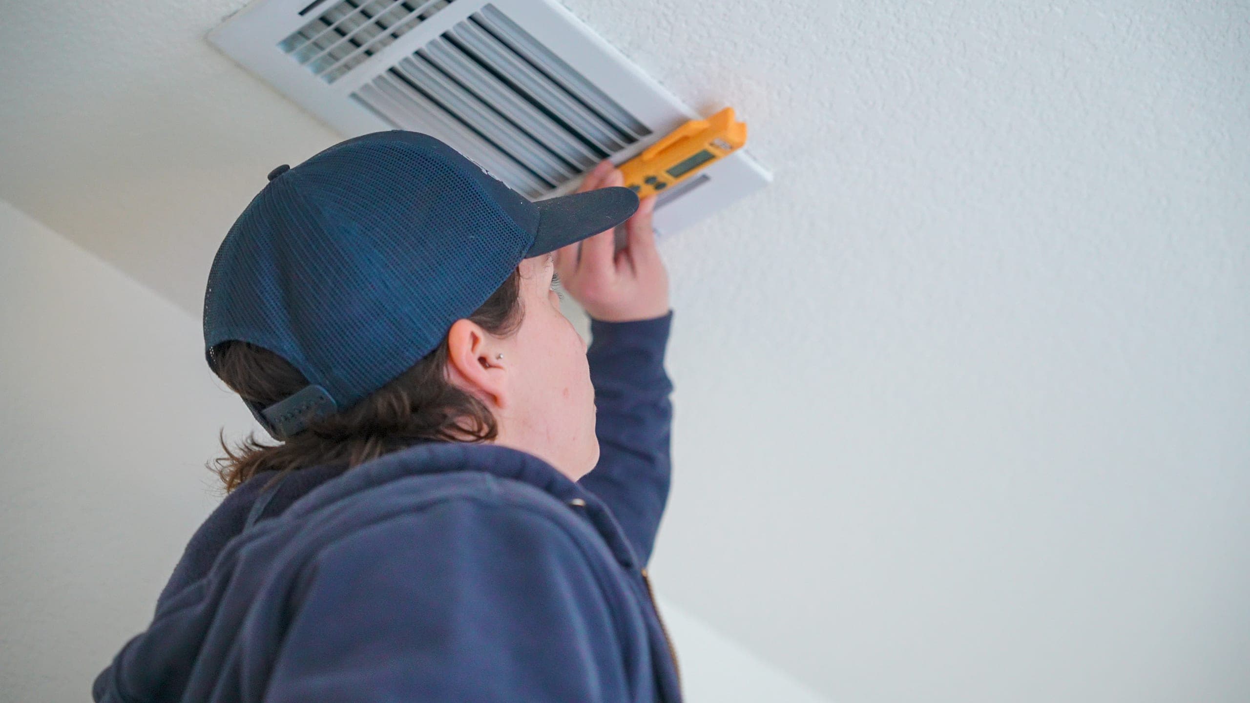 Balanced Comfort technician testing air vent quality