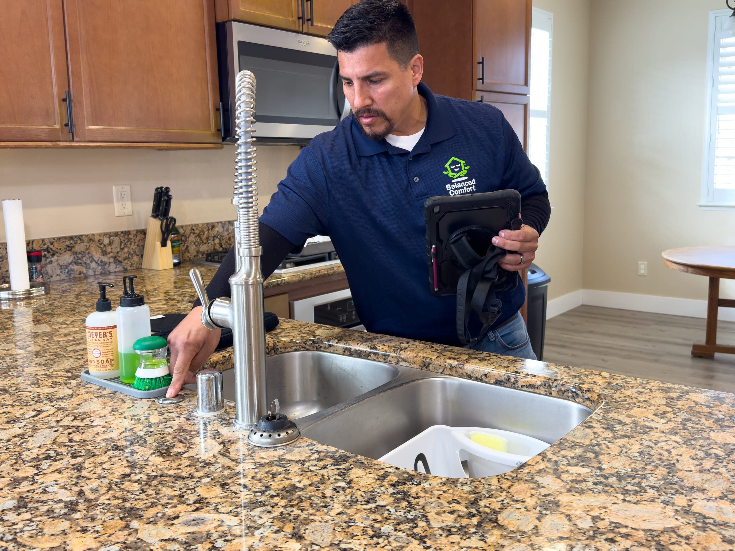 Balanced Comfort plumber clearing a clogged drain