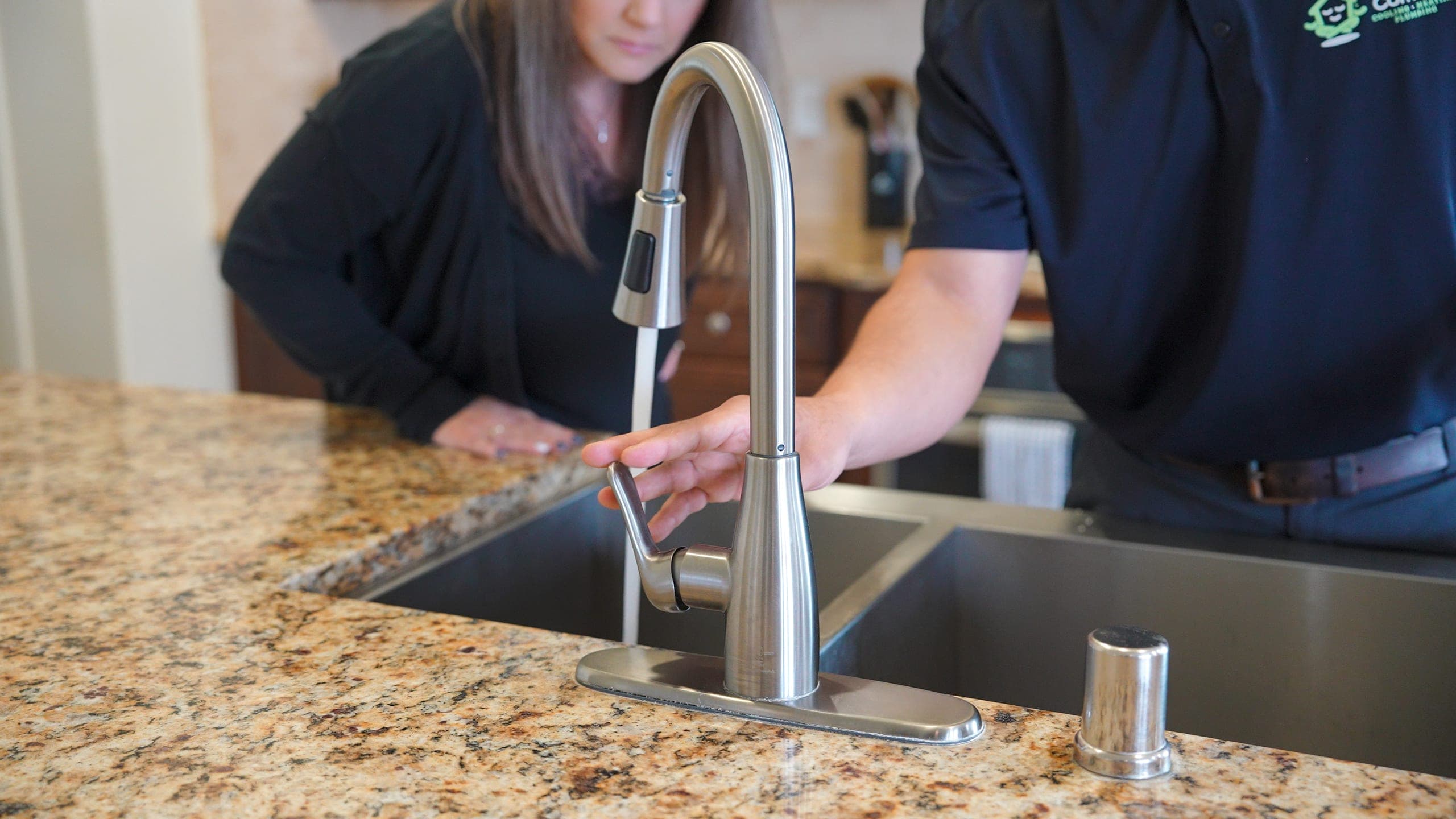 Balanced Comfort plumber reviewing the completed work with a homeowner