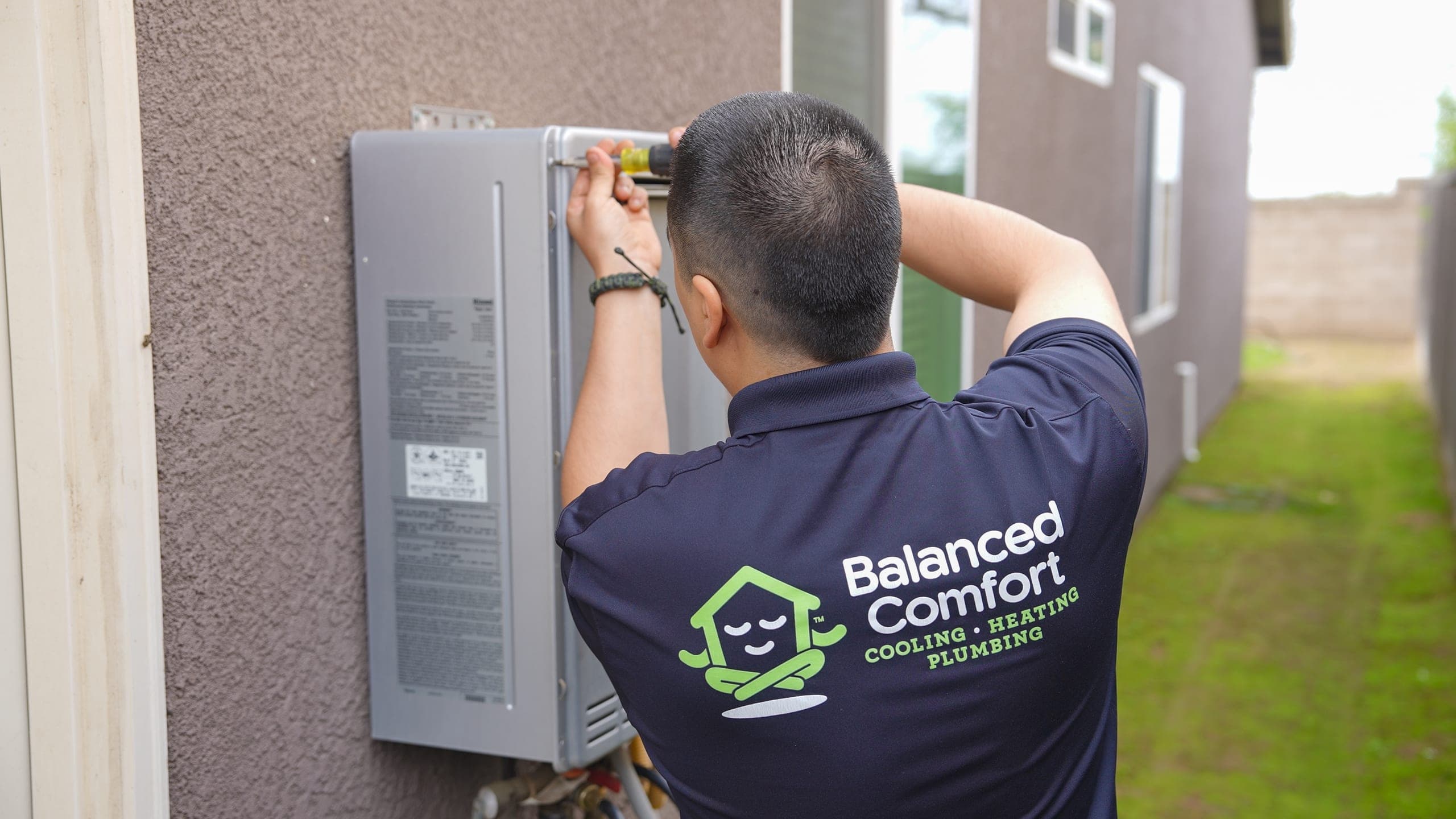 Technician repairing a commercial water heater