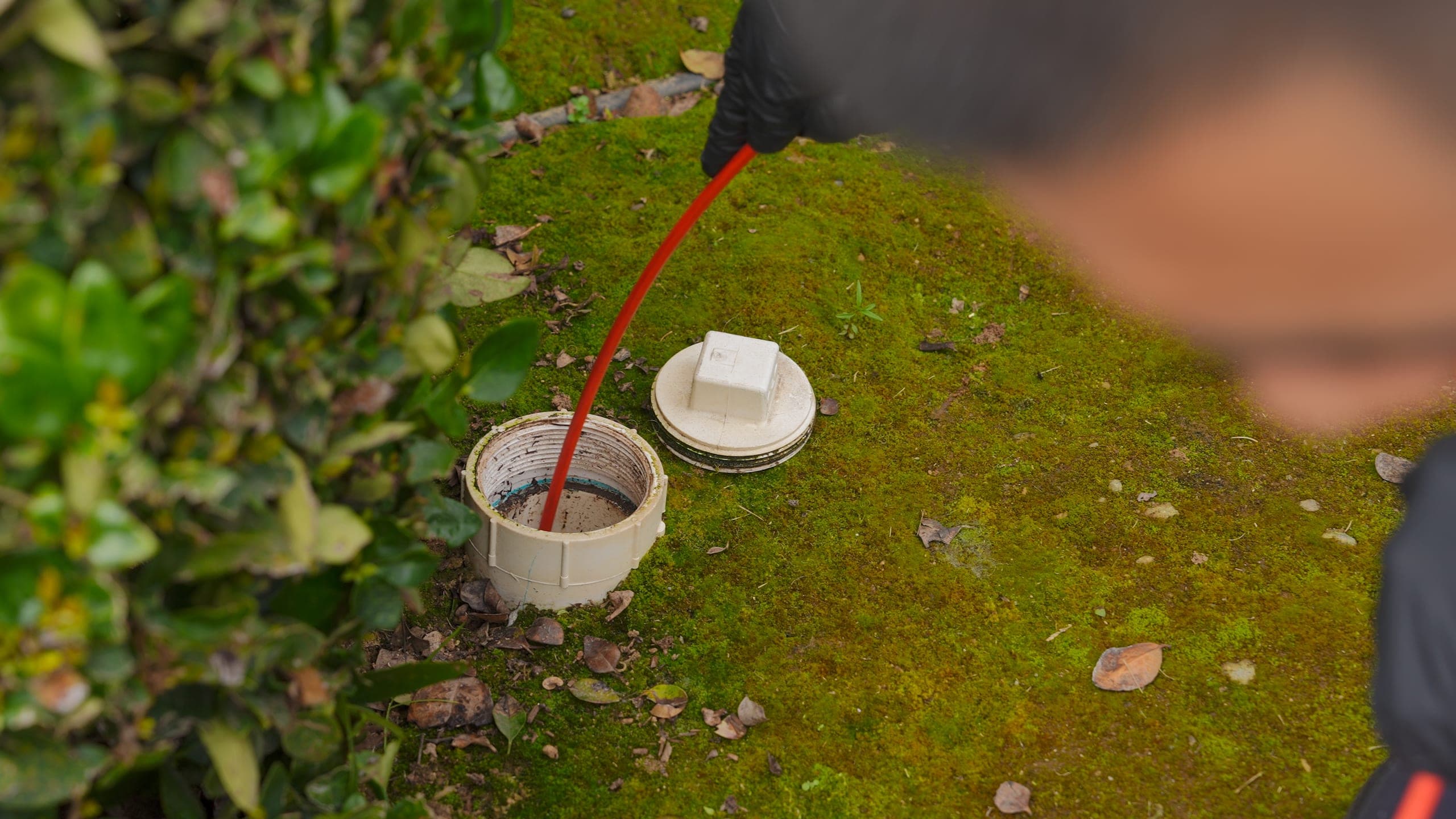 Balanced Comfort technician clearing a commercial drain