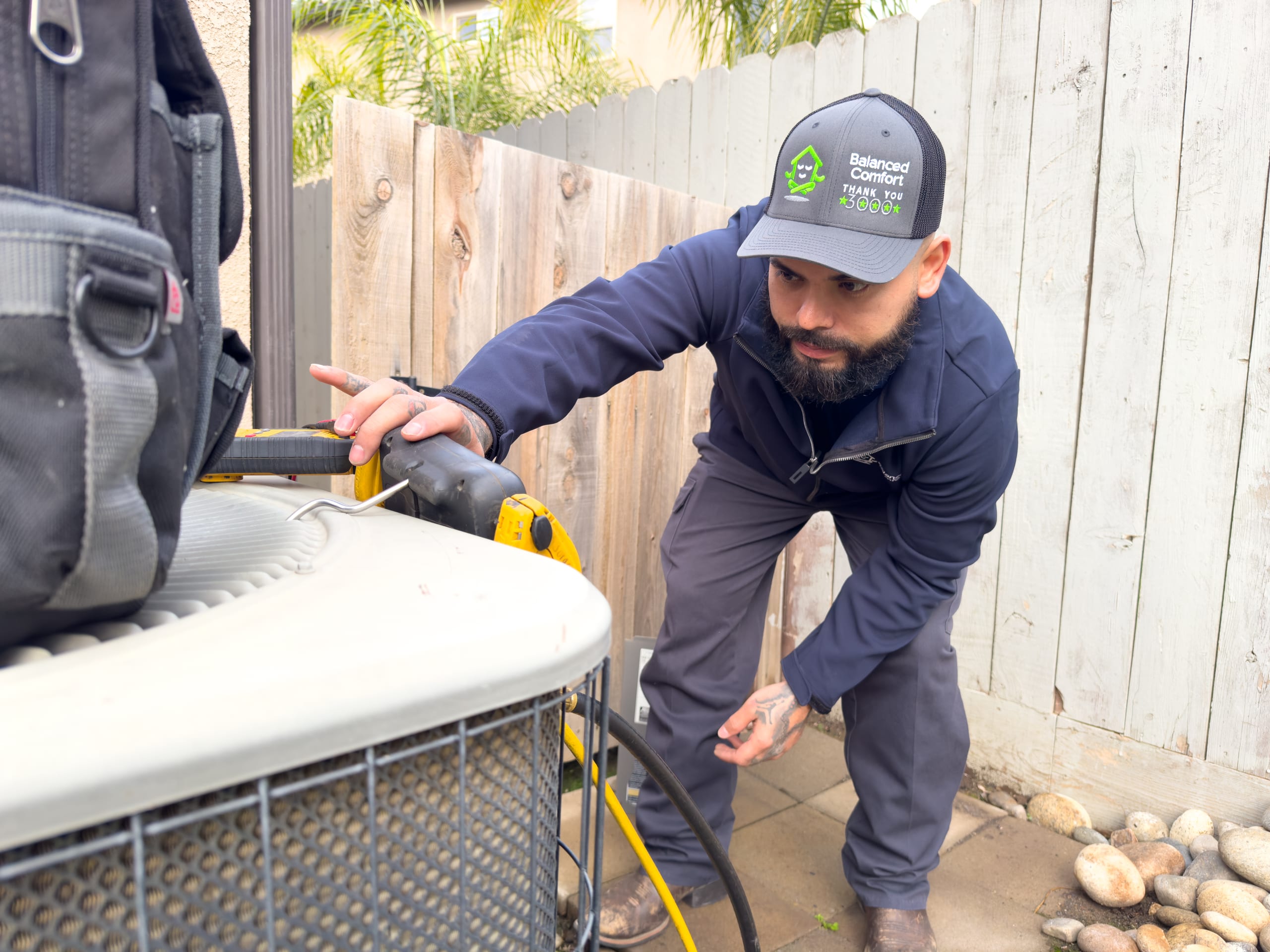 Balanced Comfort technician servicing an HVAC system