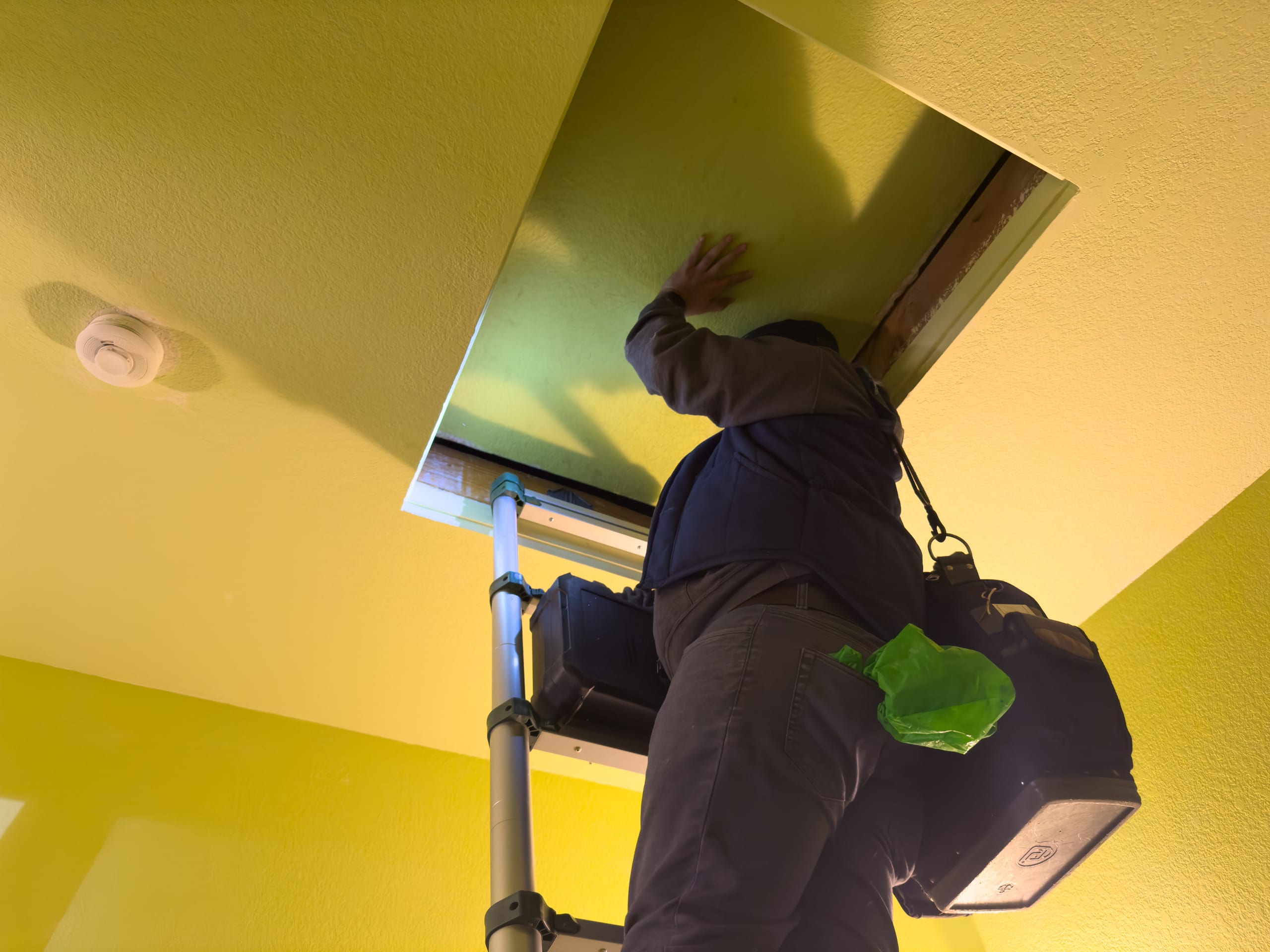 Balanced Comfort technician working in an attic