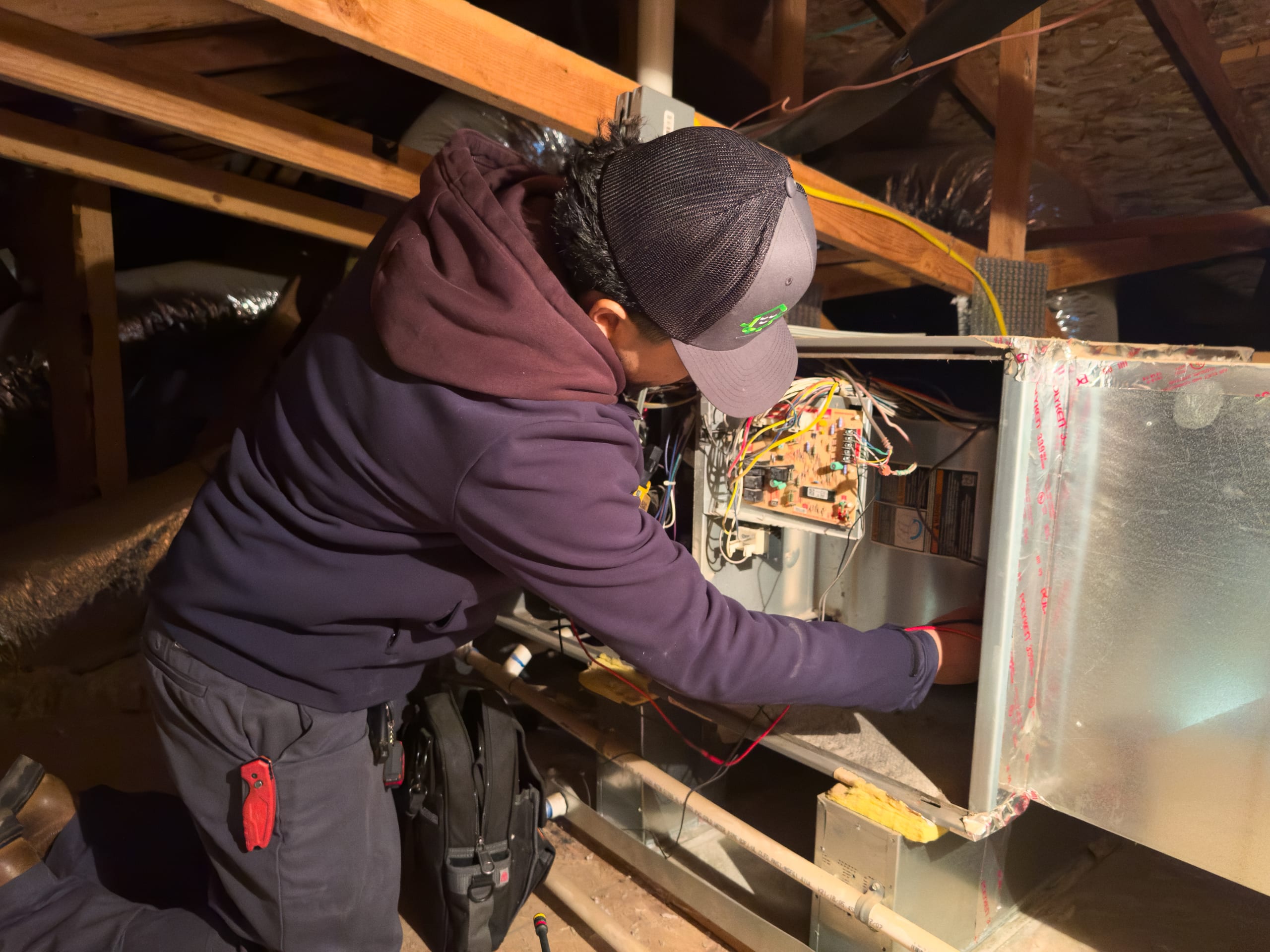 Balanced Comfort technician repairing a gas furnace