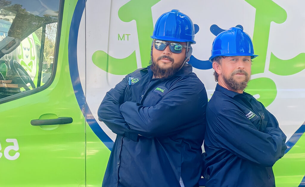 balanced comfort employees standing next to a balanced comfort truck in a residential street in the sunlight