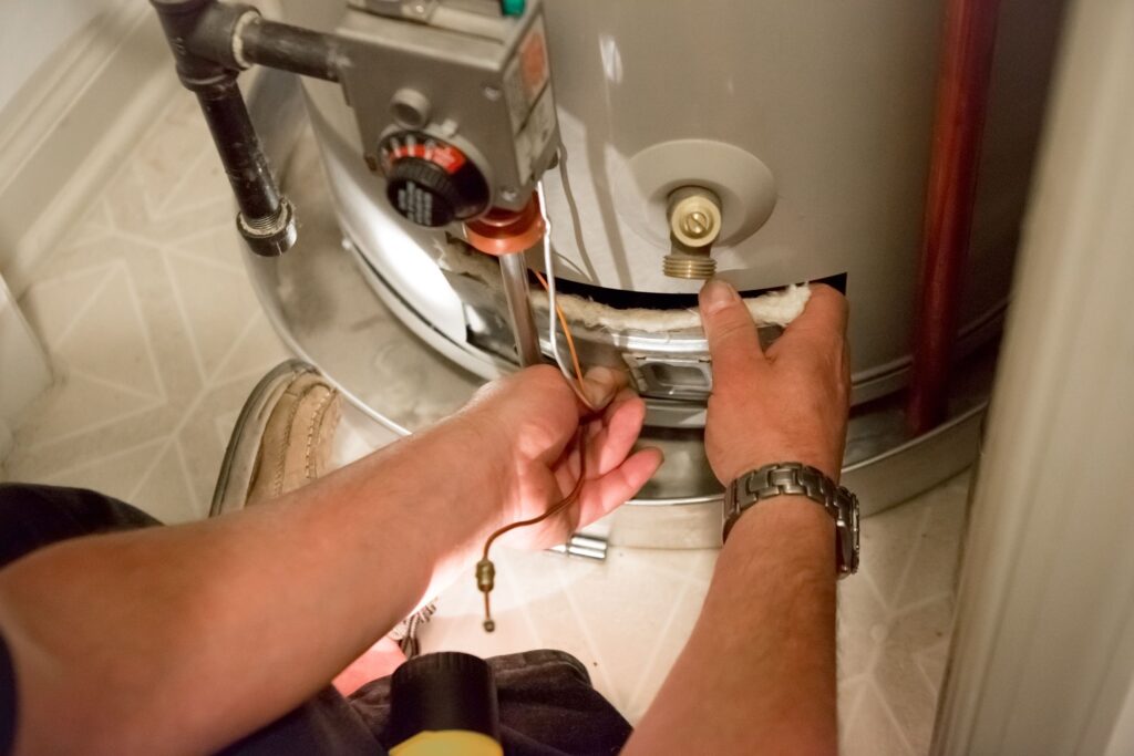 Repairing a water heater, water heater installation, and using tools to adjust a knob and wiring