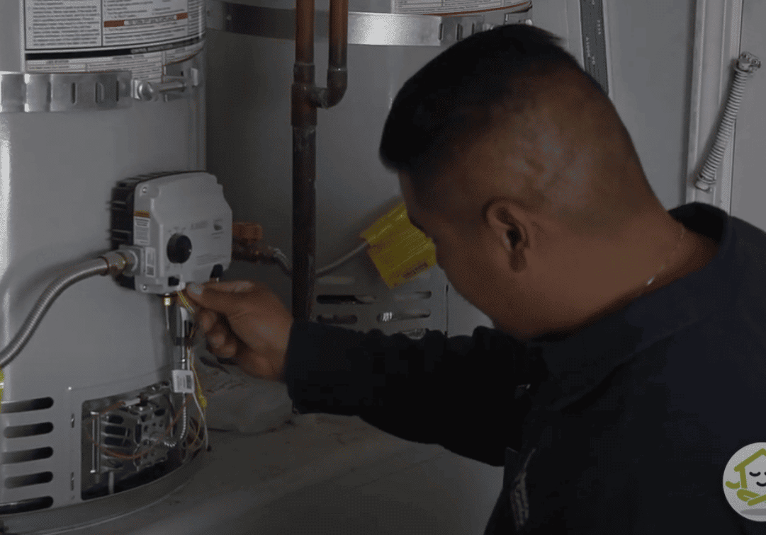 certified plumber inspecting tanked hot water heater valves