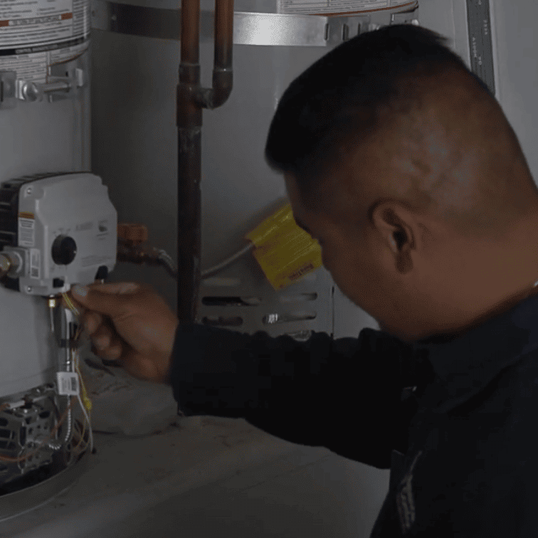 certified plumber inspecting tanked hot water heater valves