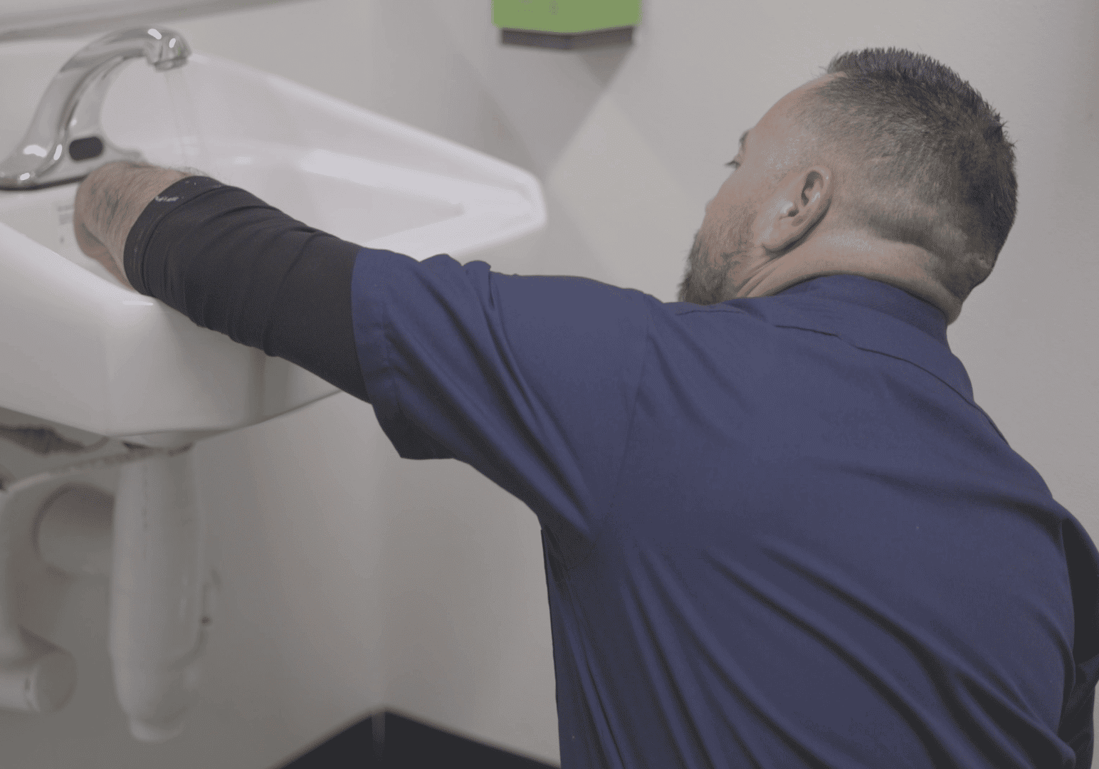 Plumber at Balanced Comfort in Fresno checking a sink to find the issue.
